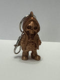Copper colored skeleton in a hoodie keychain with purse clip