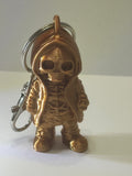 Copper colored skeleton in a hoodie keychain with purse clip