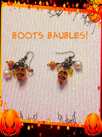 Dangle orange skull earrings