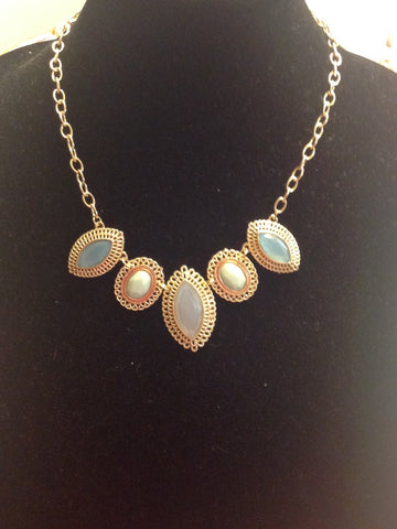 Gold tone bib style necklace in blue and white
