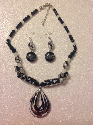 open teardrop necklace  in black and white with matching earrings.