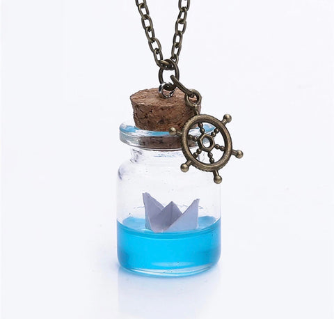 Glass bottle necklace with paper boat