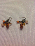 Dangle orange skull earrings