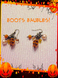 Dangle orange skull earrings