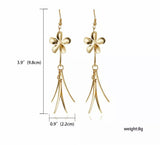 Gold tone flower dangle earrings