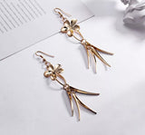 Gold tone flower dangle earrings