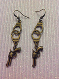 Handcuff and gun charm earrings