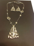 Silvertone pendant and rhinestone necklace with matching earrings