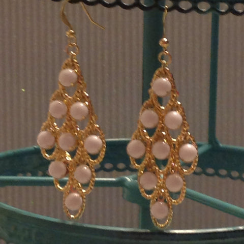 White and gold tone dangle earrings