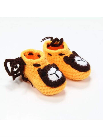 Crocheted teddy bear booties for an infant